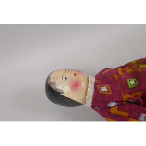 12 - A C19th German Grodnertal doll with hand painted hair, eyes, lips and cheeks, 37cm