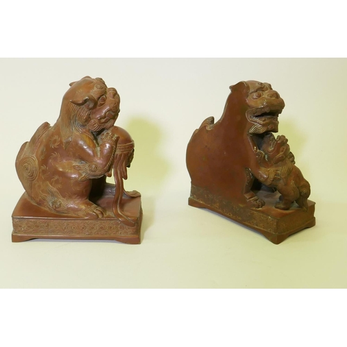 120 - A pair of bronze flat back figures of kylin, 17cm high