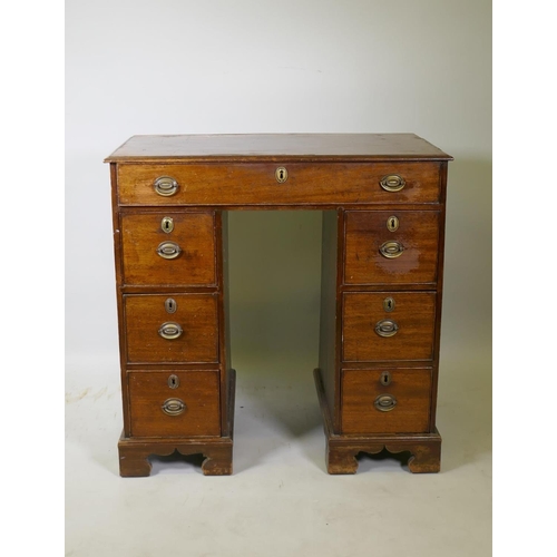 1200 - A Georgian mahogany kneehole desk, the seven drawers with cock beaded detail and original brass plat... 