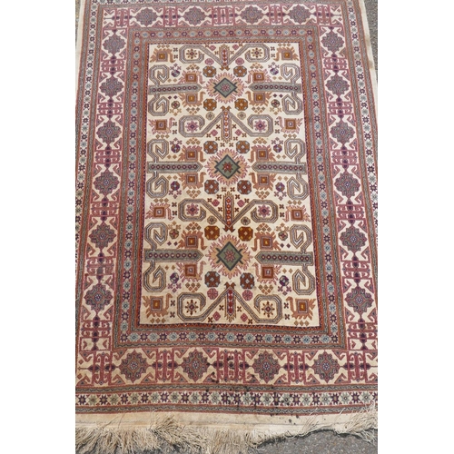 1224 - Eastern wool carpet with geometric designs on an ivory field, 118 x 166cm