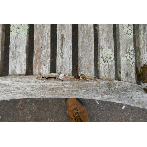 1230 - A weathered bow shaped garden bench, 160cm long