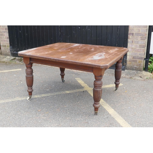 1232 - Victorian walnut windout dining table, with cut corner top, raised on reeded supports, AF, lacks lea... 