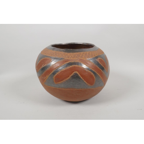 124 - A South American terracotta pot with lustre glazed details, 20cm diameter