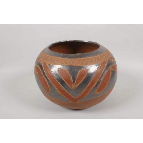 124 - A South American terracotta pot with lustre glazed details, 20cm diameter