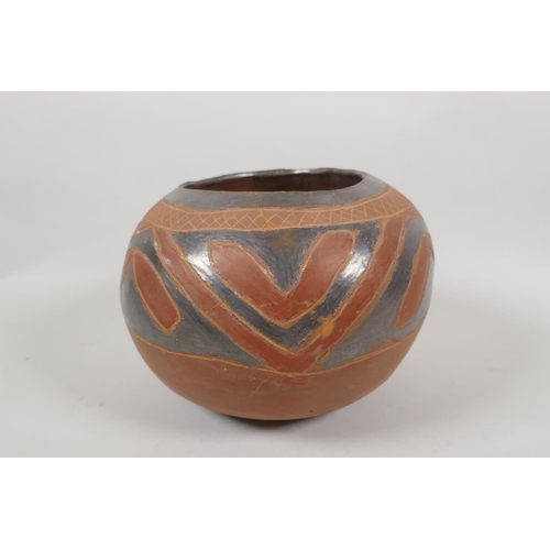 124 - A South American terracotta pot with lustre glazed details, 20cm diameter