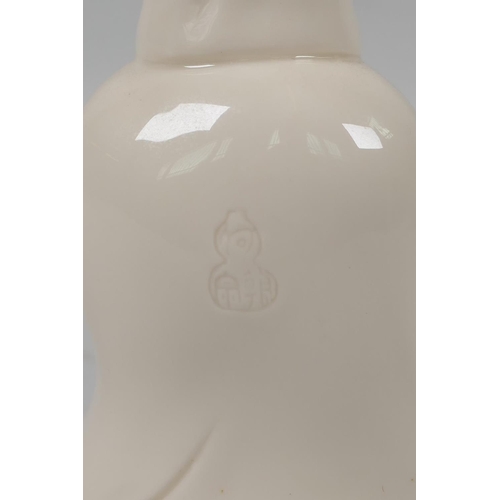 128 - A Chinese blanc de chine porcelain figure of Quan Yin, impressed mark verso, 13cm high