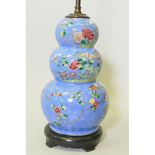 137 - A Chinese triple gourd ceramic vase with floral decoration, converted to a lamp and mounted on a woo... 