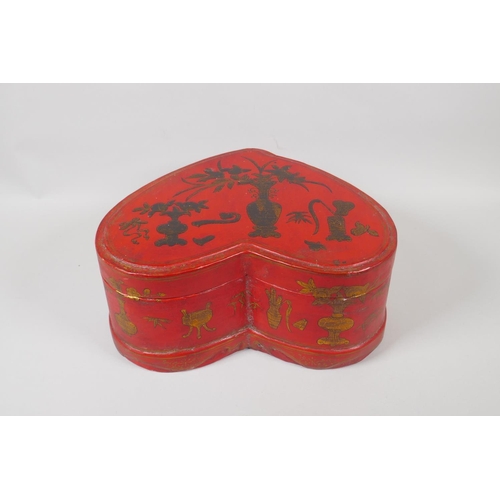 141 - A Chinese red lacquer heart shaped box, with gilt objects of virtue decoration, 32 x 26cm