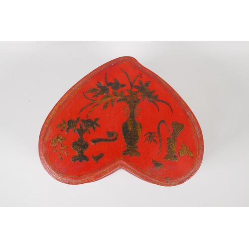 141 - A Chinese red lacquer heart shaped box, with gilt objects of virtue decoration, 32 x 26cm