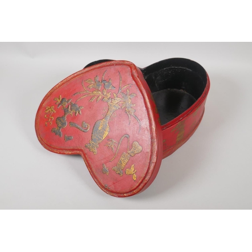 141 - A Chinese red lacquer heart shaped box, with gilt objects of virtue decoration, 32 x 26cm