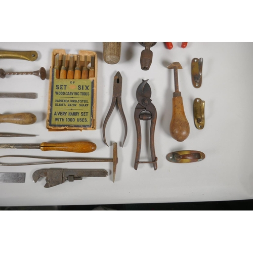 144 - A collection of vintage hand tools including floorboard saw, clamps, wood carving tools, and drills ... 