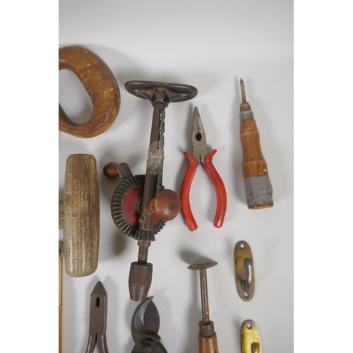 144 - A collection of vintage hand tools including floorboard saw, clamps, wood carving tools, and drills ... 