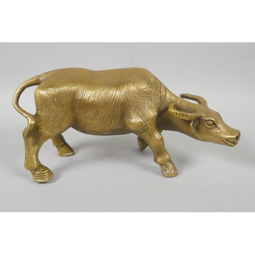 156 - A Chinese filled brass figure of a water buffalo, impressed 4 character mark to base, 26cm