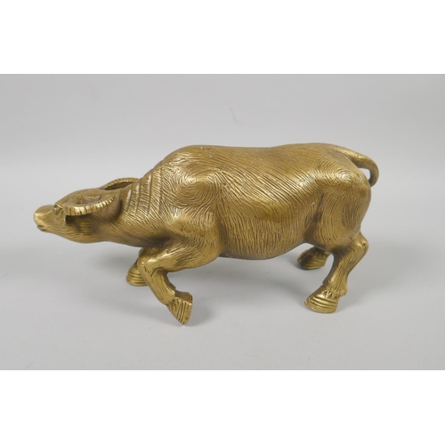 156 - A Chinese filled brass figure of a water buffalo, impressed 4 character mark to base, 26cm