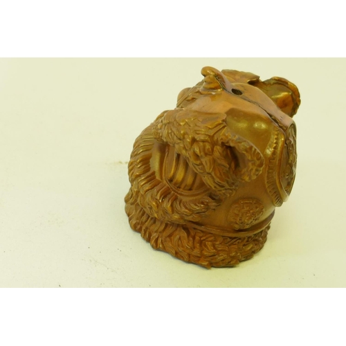 161 - A carved boxwood netsuke in the form of a foo lion, 5cm high, and a wood ball carved with a phoenix ... 