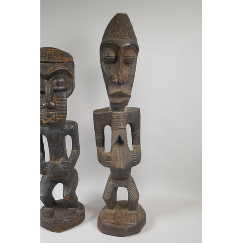 164 - Two African Democratic Republic of Congo carved wood Songye figures, a male and a female, largest 68... 