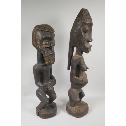 164 - Two African Democratic Republic of Congo carved wood Songye figures, a male and a female, largest 68... 