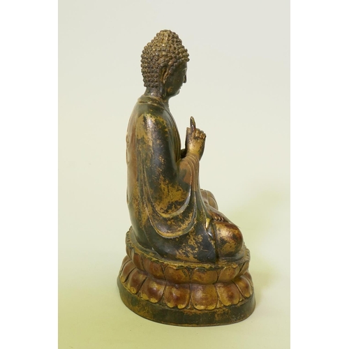 171 - A painted and gilt bronze figure of Buddha, seated upon a lotus throne, 22cm high