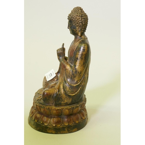 171 - A painted and gilt bronze figure of Buddha, seated upon a lotus throne, 22cm high