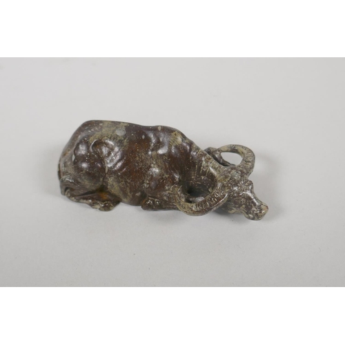 178 - A Chinese filled bronze figure of a water buffalo, impressed mark to base, 9cm