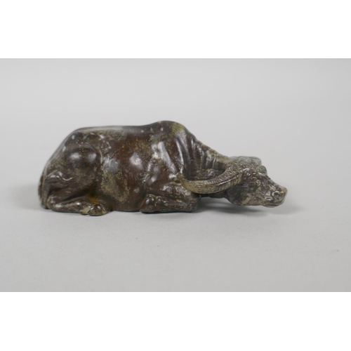 178 - A Chinese filled bronze figure of a water buffalo, impressed mark to base, 9cm