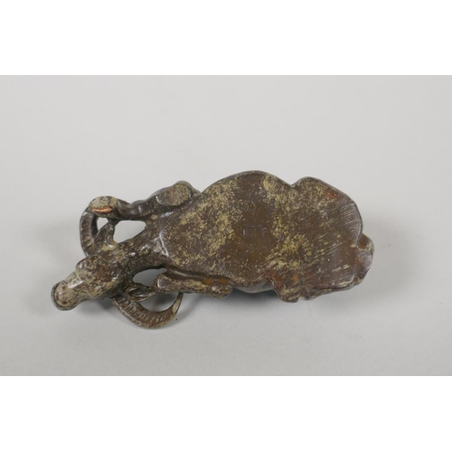 178 - A Chinese filled bronze figure of a water buffalo, impressed mark to base, 9cm