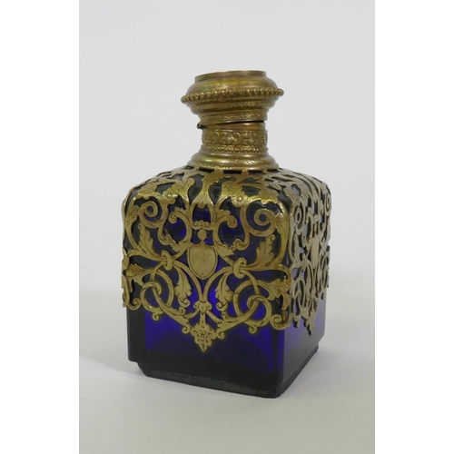 18 - A C19th French blue glass scent bottle with brass mounts, the top with inset miniature enamel painti... 