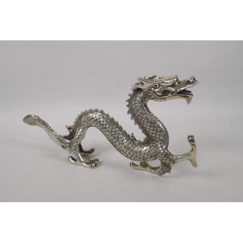 180 - A Chinese silvered metal figure of a dragon, 30cm