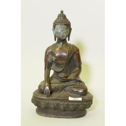 189 - An eastern bronze figure of Buddha, with brown copper patination, seated upon a lotus throne, 32cm h... 