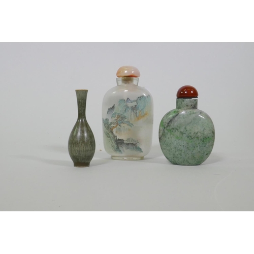 19 - A Chinese glass snuff bottle with reverse decoration of a landscape and flowering blossoms, 9.5cm hi... 