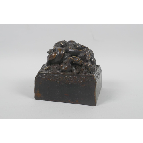 190 - A Chinese filled bronze seal decorated with kylin to the top, 10 x 10cm