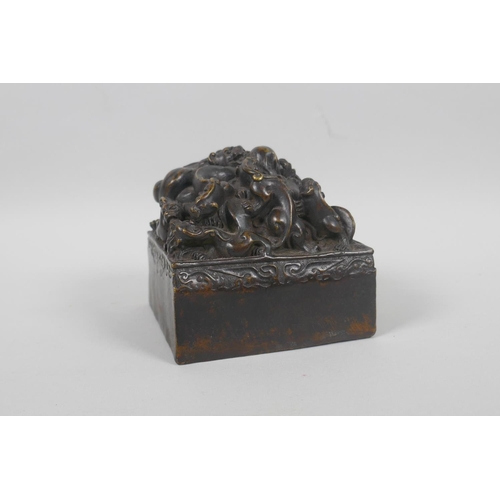 190 - A Chinese filled bronze seal decorated with kylin to the top, 10 x 10cm