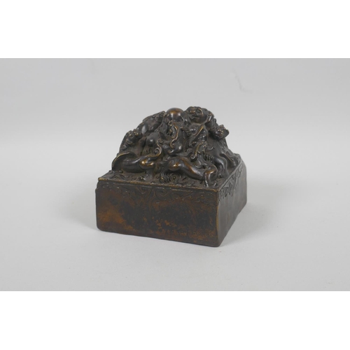 190 - A Chinese filled bronze seal decorated with kylin to the top, 10 x 10cm