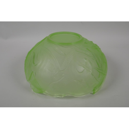 196 - A Lalique style green glass bowl with raised decoration of exotic fish, 24cm diameter