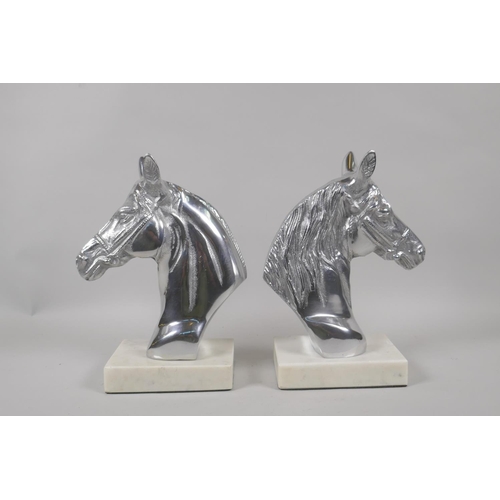 197 - A pair of chromed metal horse head bookends, 23cm high