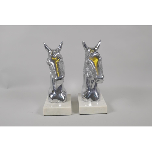 197 - A pair of chromed metal horse head bookends, 23cm high