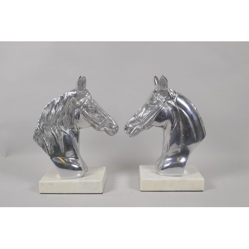 197 - A pair of chromed metal horse head bookends, 23cm high