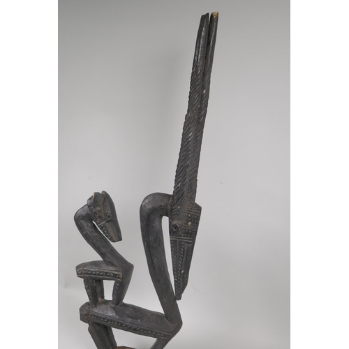 199 - An African Bamana tribe carved wood ChiWara antelope figure, 68cm high