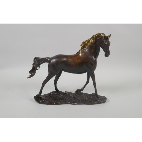 202 - A bronze figure of a horse with a gilt mane, 24cm long