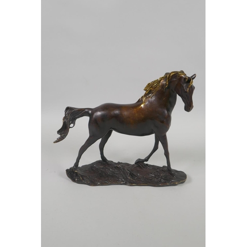 202 - A bronze figure of a horse with a gilt mane, 24cm long