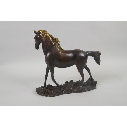 202 - A bronze figure of a horse with a gilt mane, 24cm long