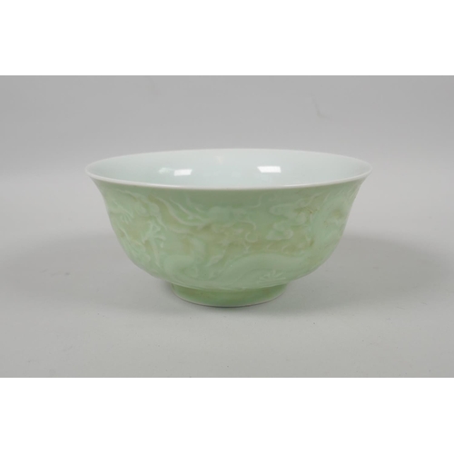 203 - A Chinese celadon glazed porcelain bowl with raised underglaze dragon decoration, 5 character mark t... 