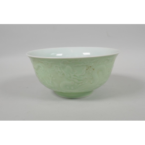 203 - A Chinese celadon glazed porcelain bowl with raised underglaze dragon decoration, 5 character mark t... 