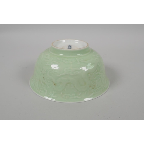 203 - A Chinese celadon glazed porcelain bowl with raised underglaze dragon decoration, 5 character mark t... 