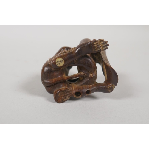 206 - A Japanese carved wood erotic shunga netsuke, signed in an inset cartouche to base, 4.5cm