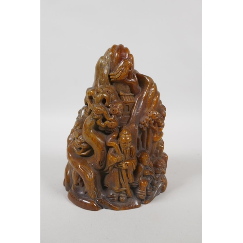 213 - A Chinese carved faux horn ornament decorated with figures in a mountain landscape, mark to base, 18... 