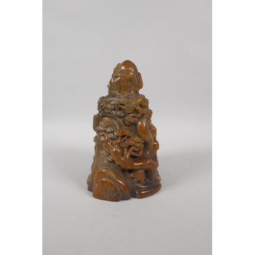 213 - A Chinese carved faux horn ornament decorated with figures in a mountain landscape, mark to base, 18... 