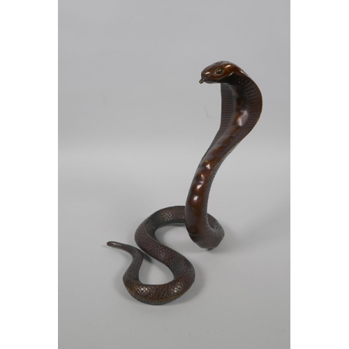 216 - A filled bronze figure of a cobra, 18cm high