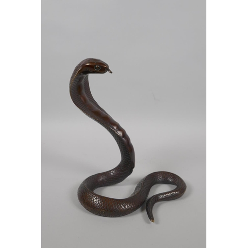 216 - A filled bronze figure of a cobra, 18cm high