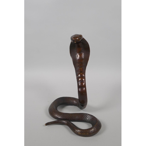 216 - A filled bronze figure of a cobra, 18cm high